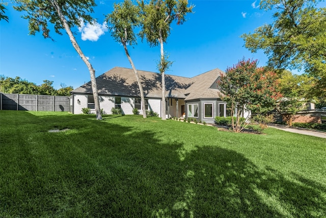 back of house with a lawn