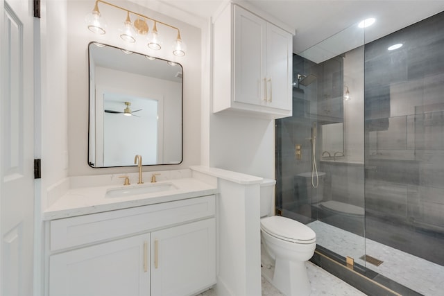 bathroom featuring ceiling fan, vanity, toilet, and an enclosed shower