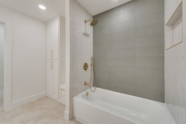 bathroom featuring tiled shower / bath and tile patterned flooring