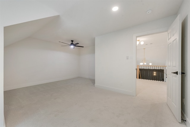 additional living space with ceiling fan with notable chandelier, lofted ceiling, and light carpet