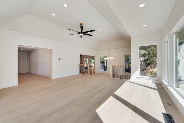 unfurnished living room with light wood-type flooring, ceiling fan with notable chandelier, and crown molding