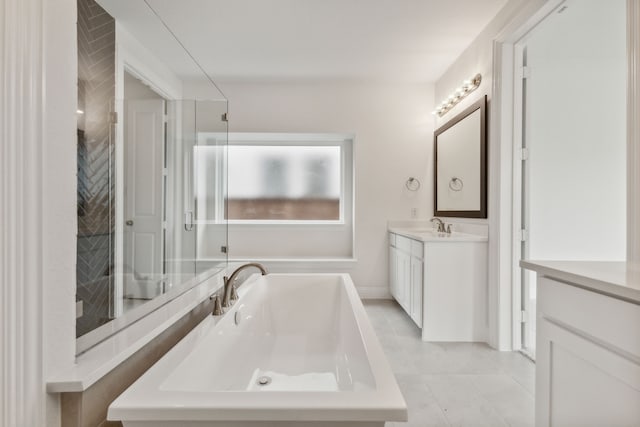 bathroom with tile patterned flooring, vanity, and walk in shower