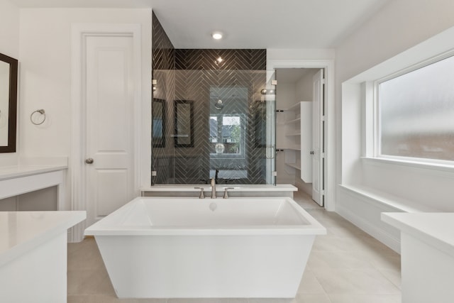 bathroom with vanity, tile patterned floors, and a bathtub