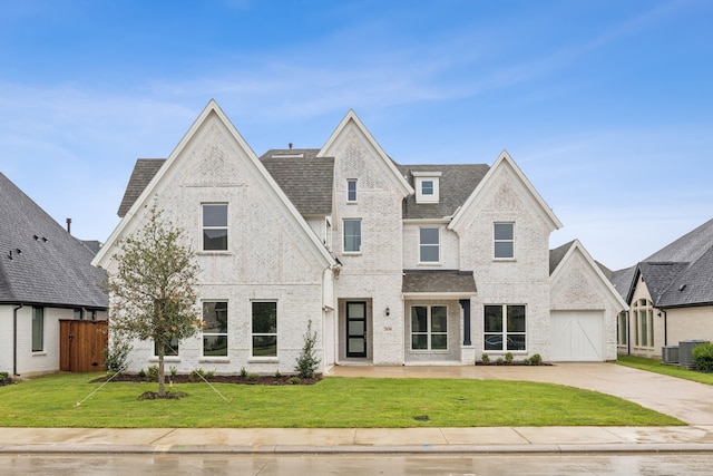 view of front of house with a front yard and central AC unit