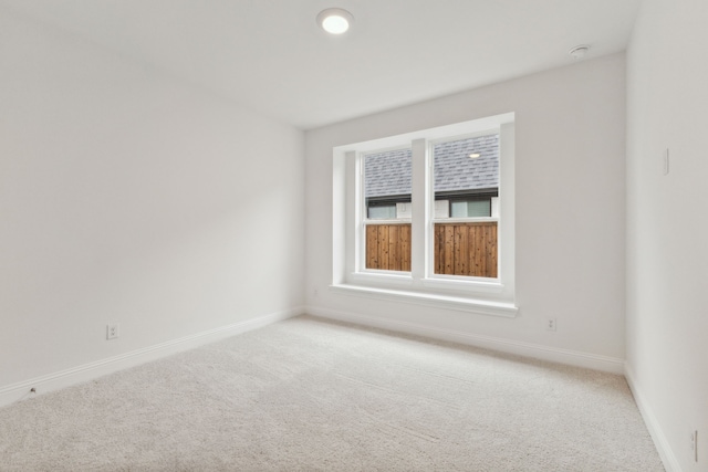 empty room featuring light carpet