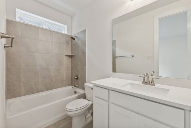 full bathroom with tile patterned flooring, vanity, toilet, and tiled shower / bath