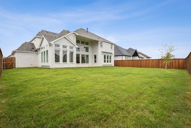 back of house featuring a lawn