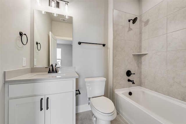 full bathroom featuring tile patterned floors, tiled shower / bath combo, vanity, and toilet