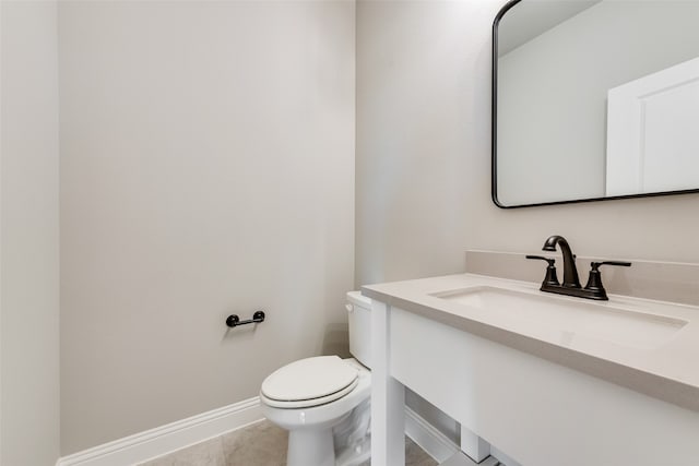 bathroom featuring tile patterned flooring, vanity, and toilet