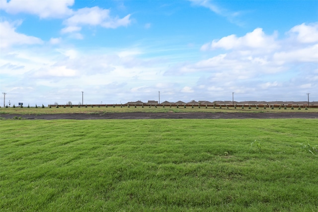 surrounding community with a rural view and a yard