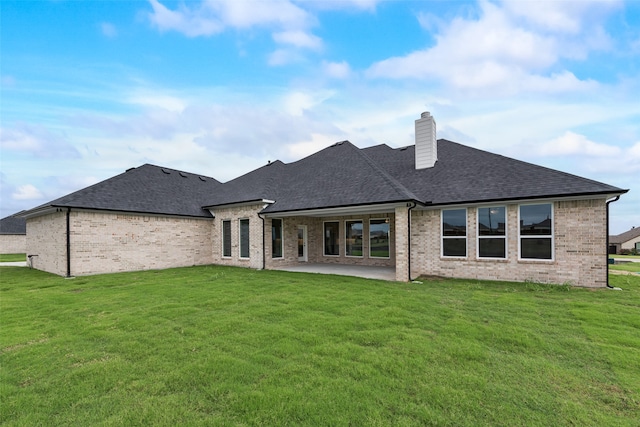 back of house featuring a patio and a yard