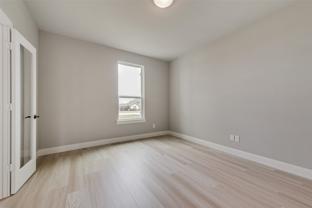 spare room with light hardwood / wood-style flooring