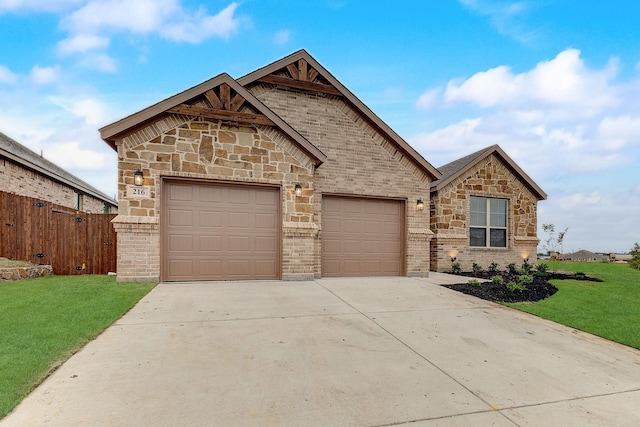 view of front facade with a garage and a front lawn