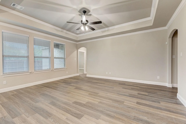 unfurnished room featuring ornamental molding, a tray ceiling, ceiling fan, and hardwood / wood-style flooring