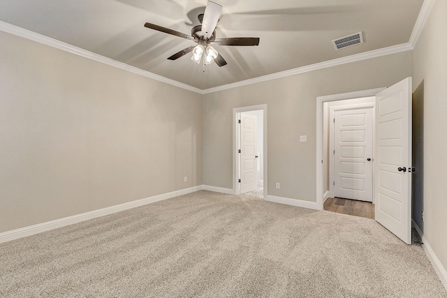 unfurnished bedroom with ornamental molding, ceiling fan, and light colored carpet