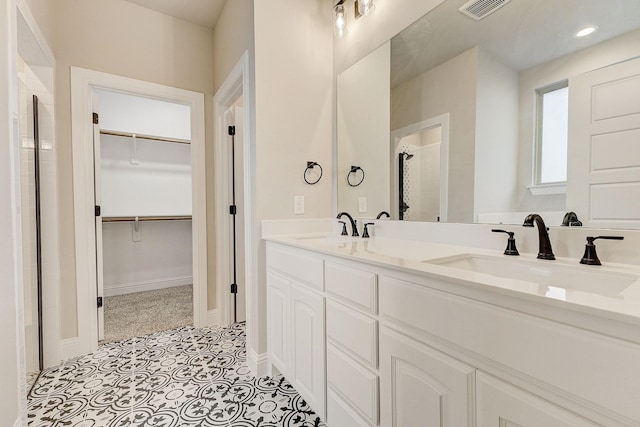 bathroom with a shower and vanity