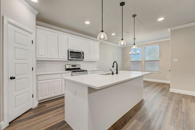 kitchen with white cabinets, a center island with sink, stainless steel appliances, and sink