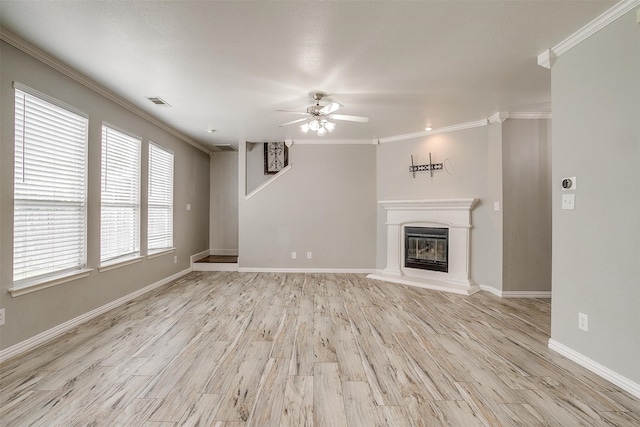 unfurnished living room featuring light hardwood / wood-style floors, ornamental molding, and ceiling fan