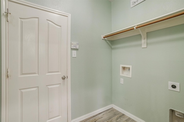 laundry area with hookup for a washing machine, light hardwood / wood-style floors, and electric dryer hookup