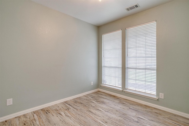 spare room featuring light wood-type flooring