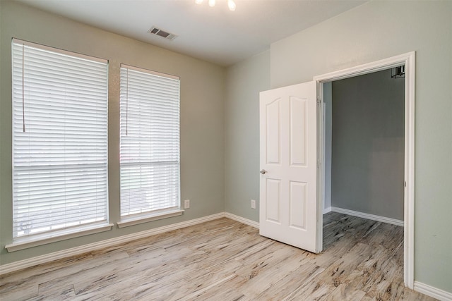 unfurnished room featuring light wood-type flooring