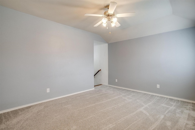 carpeted spare room with lofted ceiling and ceiling fan