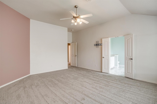 carpeted spare room with lofted ceiling and ceiling fan