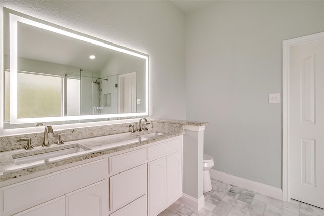 bathroom featuring vanity, an enclosed shower, and toilet