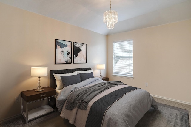 carpeted bedroom featuring vaulted ceiling and an inviting chandelier