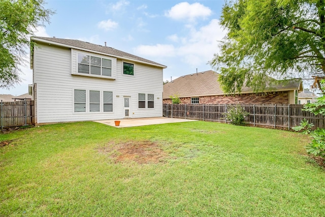 rear view of house with a patio and a yard