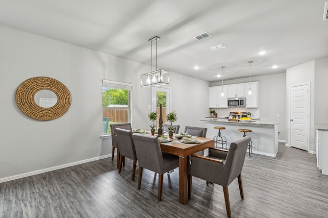 dining space with dark hardwood / wood-style floors