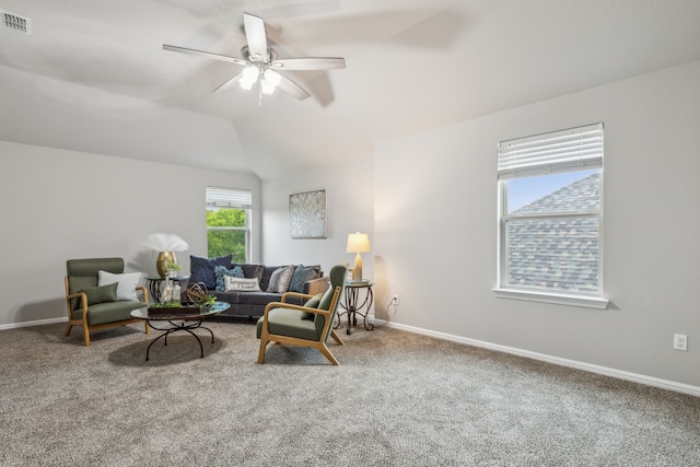 living room with carpet floors, lofted ceiling, and ceiling fan