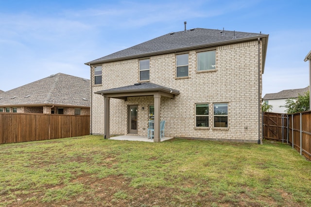 back of house with a lawn and a patio area