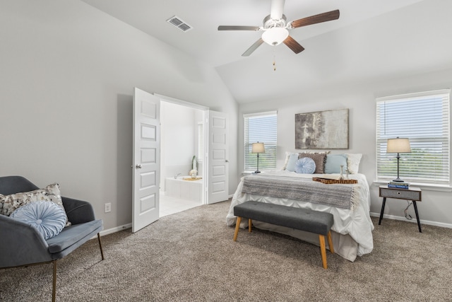 bedroom featuring ceiling fan, ensuite bathroom, vaulted ceiling, and multiple windows