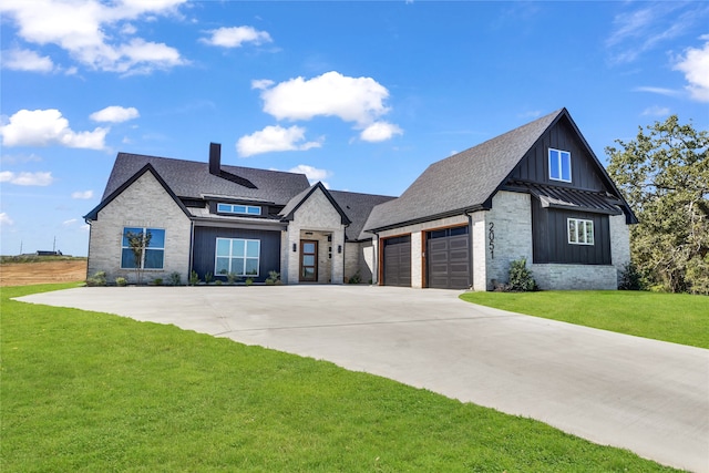 view of front of home with a front yard and a garage