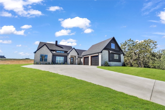 view of front of property featuring a garage and a front lawn