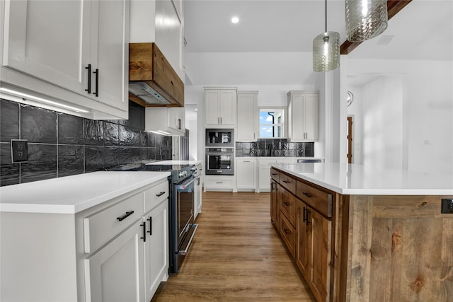 kitchen featuring stainless steel appliances, a center island, and white cabinetry