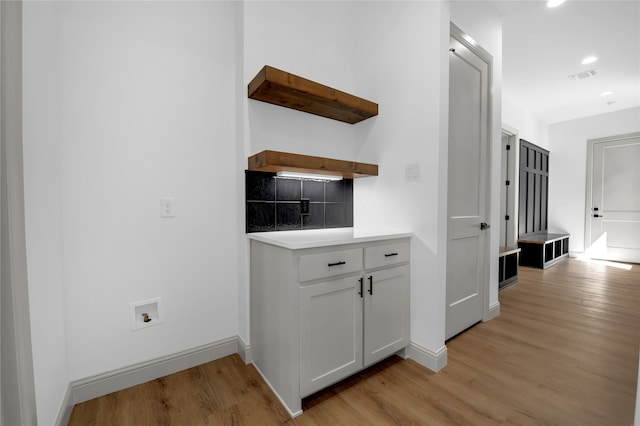 corridor with light hardwood / wood-style floors