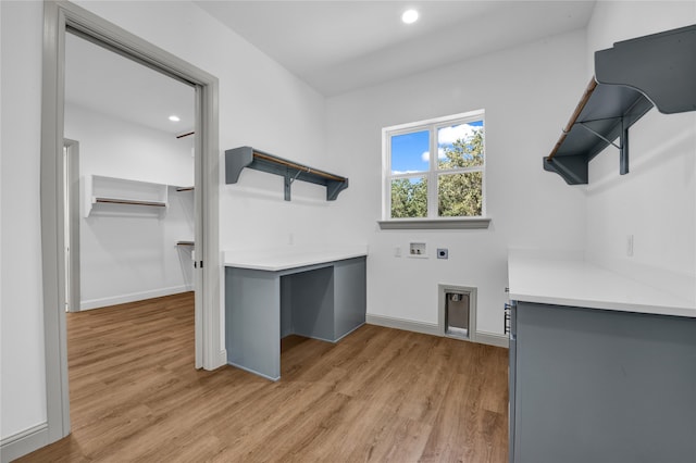 washroom with hookup for a washing machine, light hardwood / wood-style flooring, and electric dryer hookup