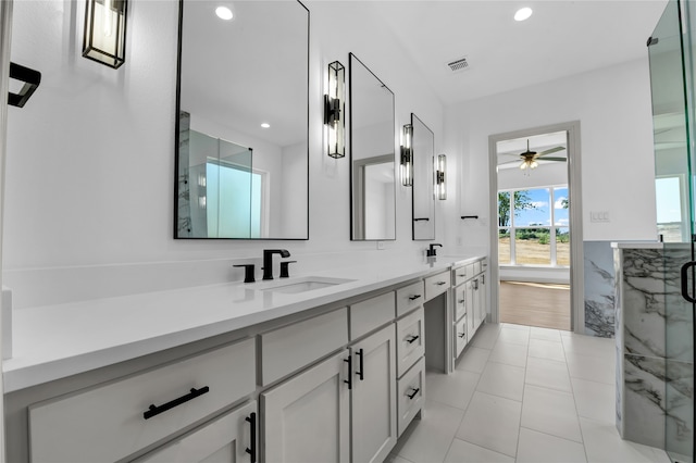 bathroom with tile patterned floors, ceiling fan, walk in shower, and vanity