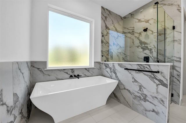 bathroom with tile patterned floors, tile walls, and plus walk in shower