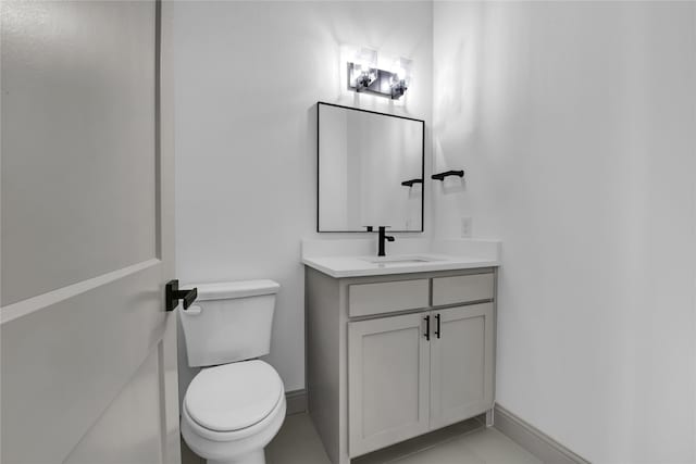 bathroom with tile patterned flooring, vanity, and toilet