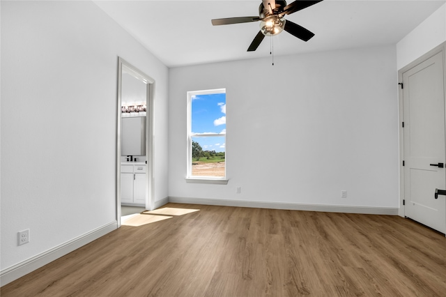 unfurnished bedroom with light wood-type flooring, ensuite bath, and ceiling fan