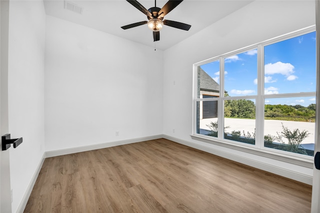 unfurnished room with light wood-type flooring and ceiling fan