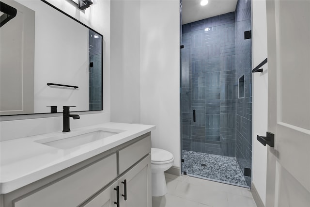 bathroom with vanity, a shower with shower door, and toilet