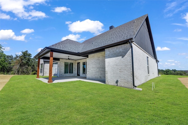 rear view of house with a yard, ceiling fan, and a patio