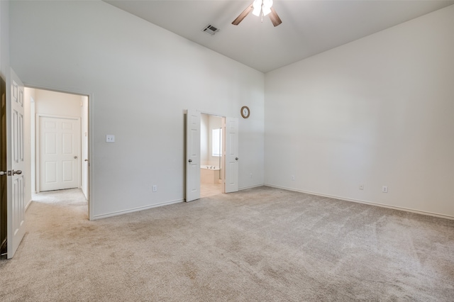 unfurnished bedroom with high vaulted ceiling, ceiling fan, and light colored carpet