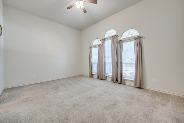 carpeted empty room featuring lofted ceiling and ceiling fan