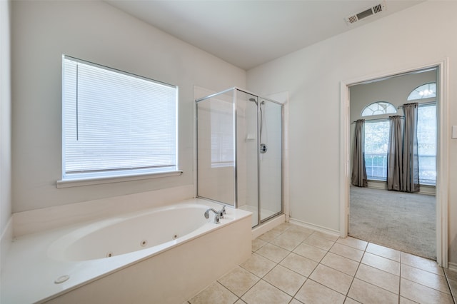 bathroom with tile patterned flooring, a healthy amount of sunlight, and separate shower and tub