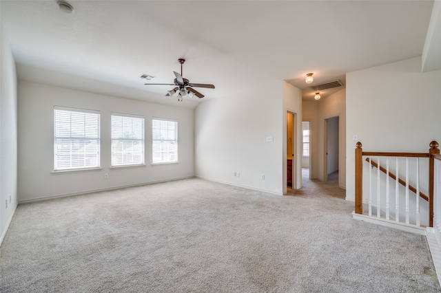 empty room with ceiling fan and light colored carpet